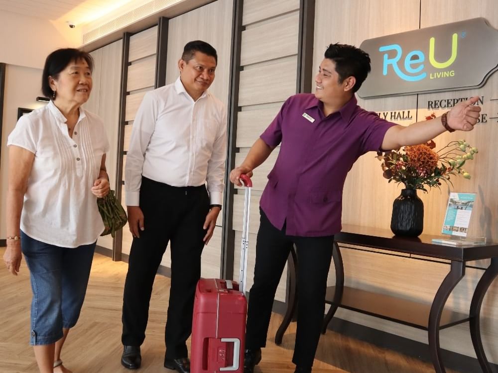 Hotel staff navigating an old couple into the hotel reception at MiCasa All Suite Hotel KL