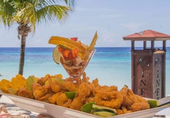 A plate of shrimp & a cocktail by the sea at  Infinity Bay