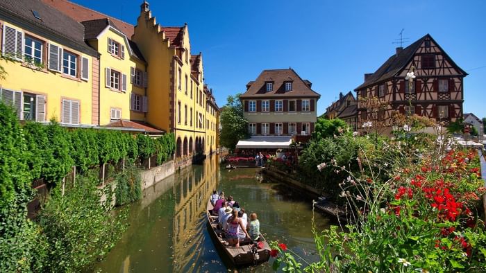 Boat tour on a canal in Colmar near the Originals Hotels