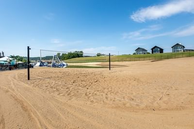 Sandy volleyball court with a net in a sunny landscape near Off Shore Resort