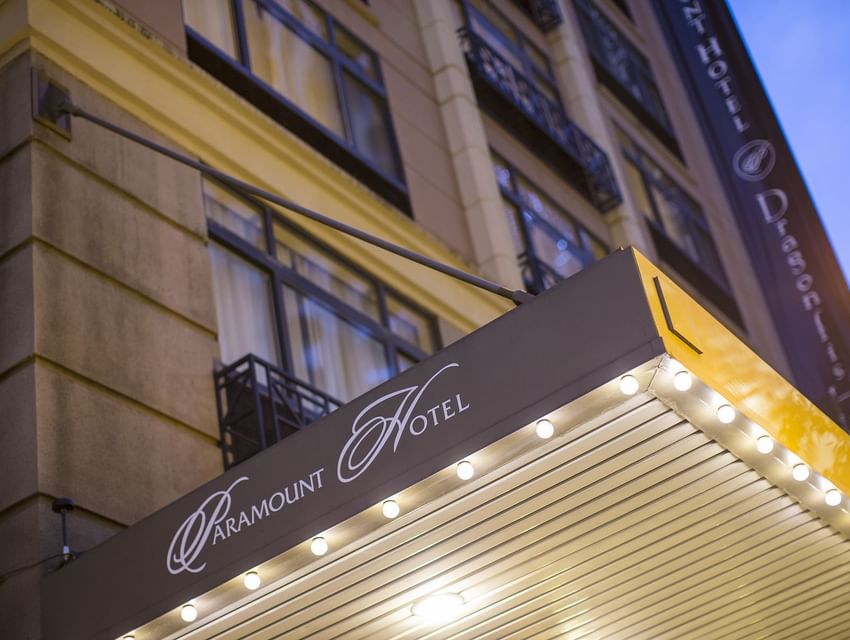 The entrance canopy of The Paramount Hotel Seattle with the illuminated logo and an awning with lights