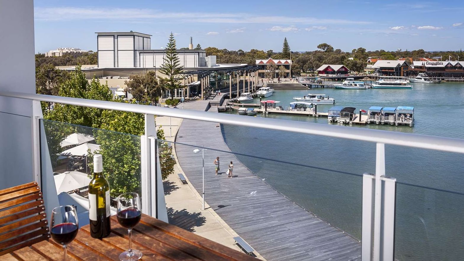 Scenic view from Water View Superior King balcony at The Sebel Mandurah overlooking a marina with boats and a boardwalk