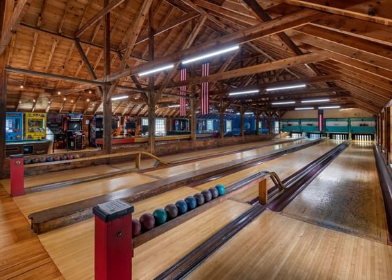 Illuminated bowling alley with gaming machines & bowling balls at Sebasco Harbor Resort