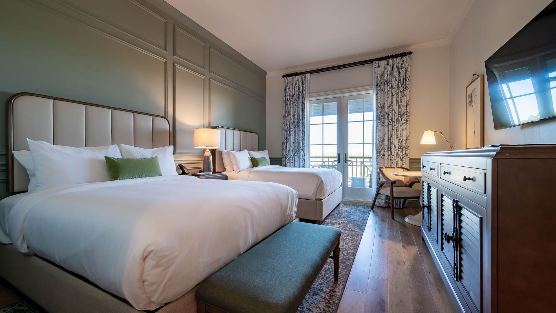 Drawer & TV facing the twin beds in Queen Room With Balcony at Camp Creek Inn