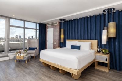 a bed and chair in a hotel room