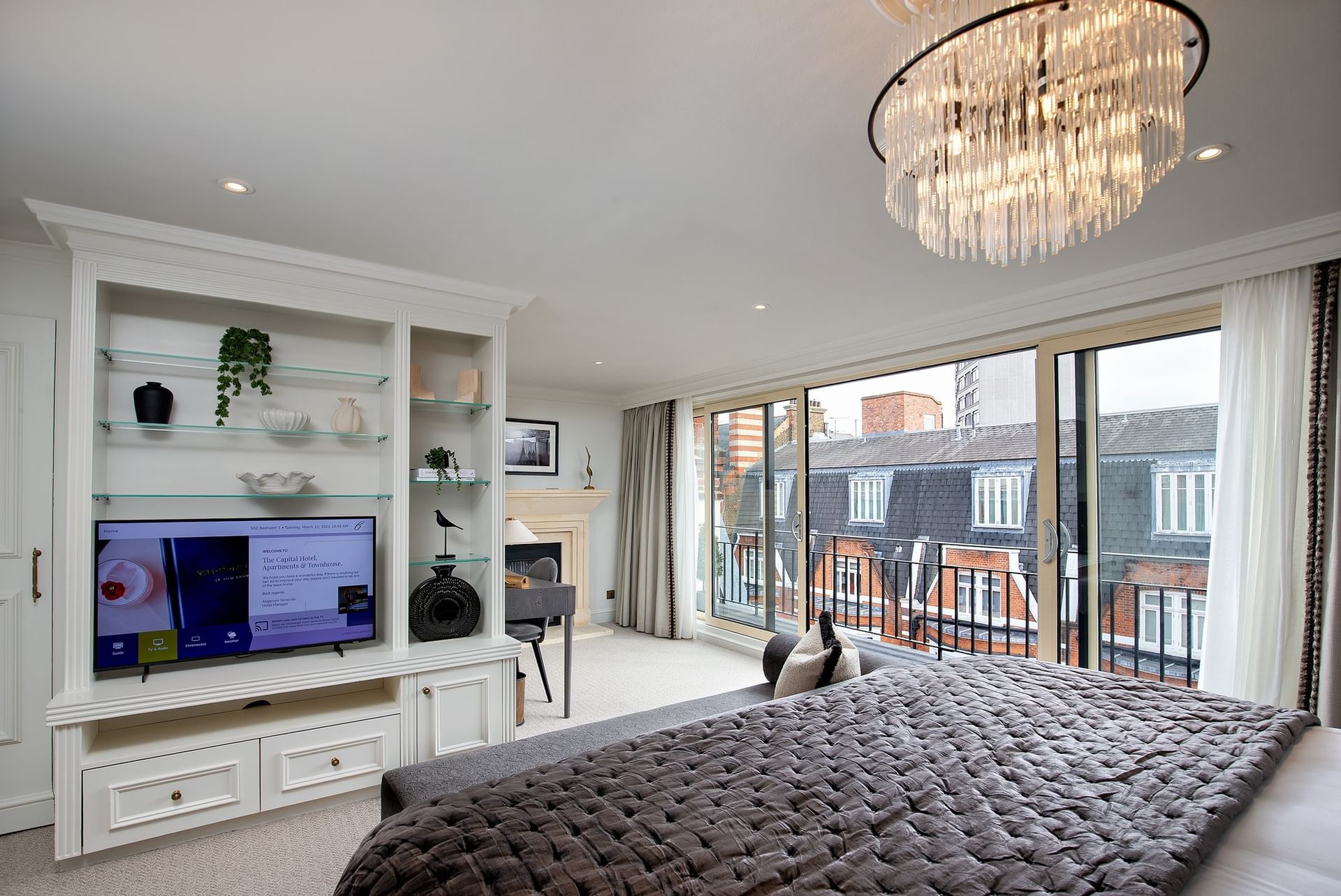 Bed with plush pillows under wall lamps in Hyde Park Suite at The Capital Hotel, Apartments and Townhouse