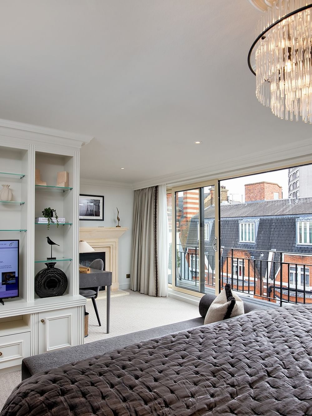 Elegant penthouse bedroom with large bed and city view at The Capital Hotel, Apartments & Townhouse - London.