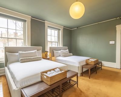 Two single beds by the windows in Luxury Two Queen room at The Ashbrook Hotel