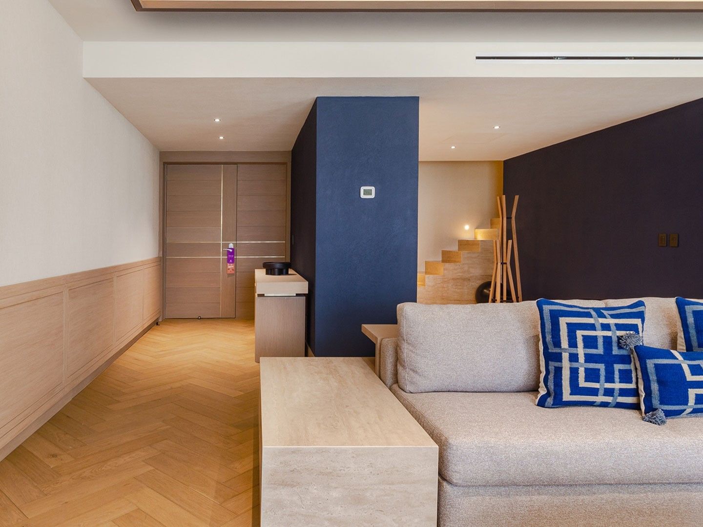King Superior Viceroys Suite featuring a blue accent wall and chevron patterned floors at Camino Real Polanco Mexico
