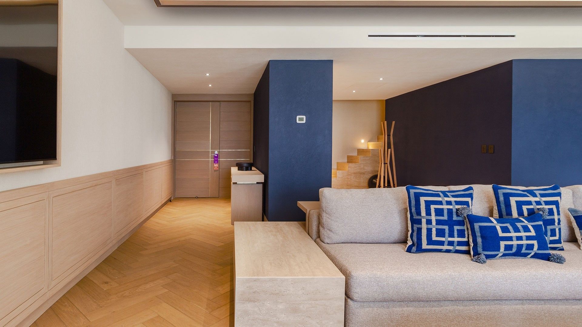 King Superior Viceroys Suite featuring a blue accent wall and chevron patterned floors at Camino Real Polanco Mexico
