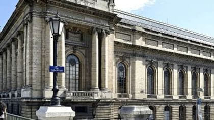 Musee Art et Histoire building by a street lamp under a soft blue sky near Warwick Geneva