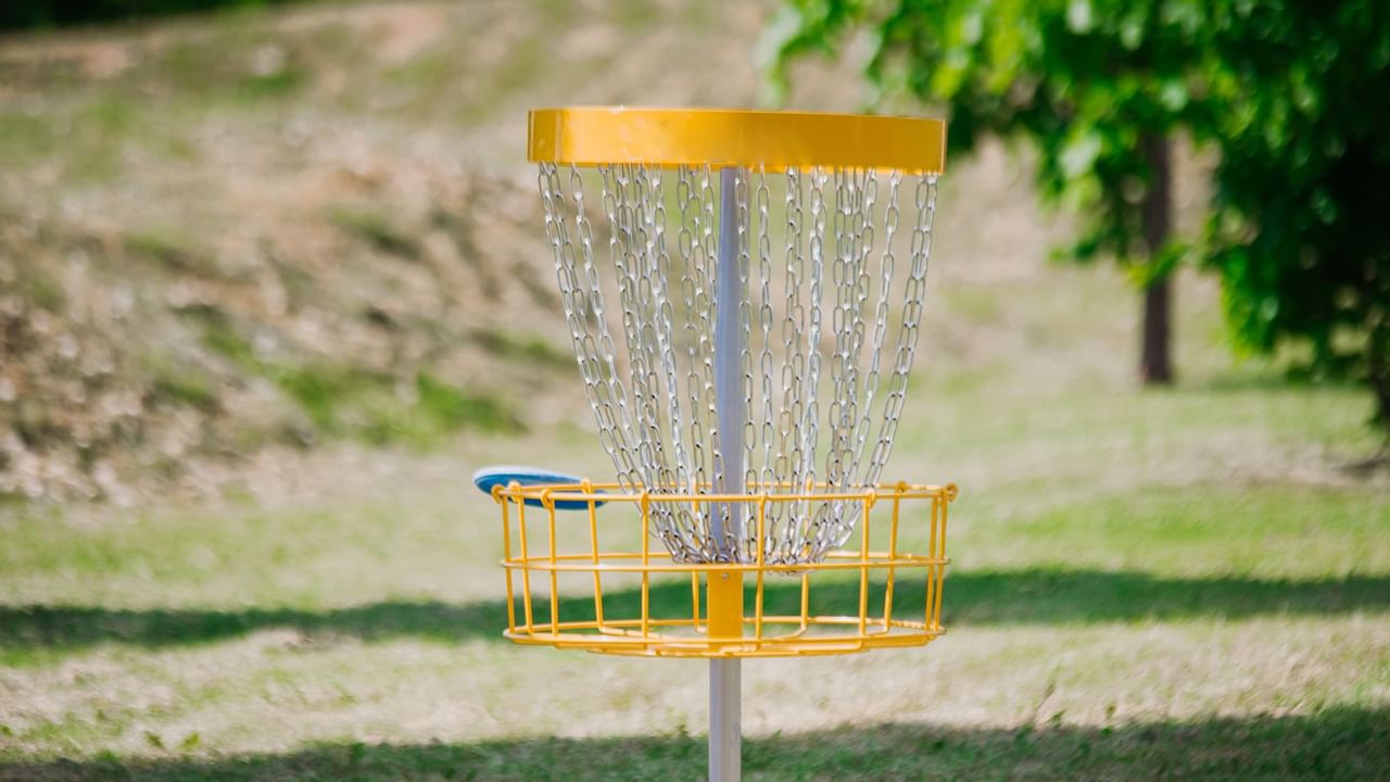 yellow disc golf basket