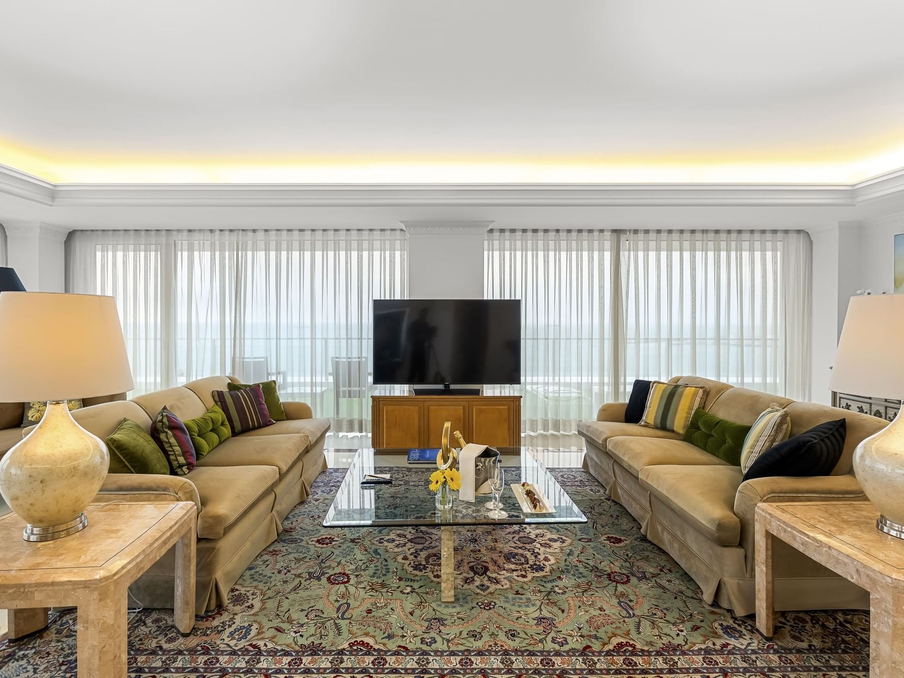 Royal Suite living room with sofas, table, and TV at Hotel Cascais Miragem Health & Spa in Cascais.