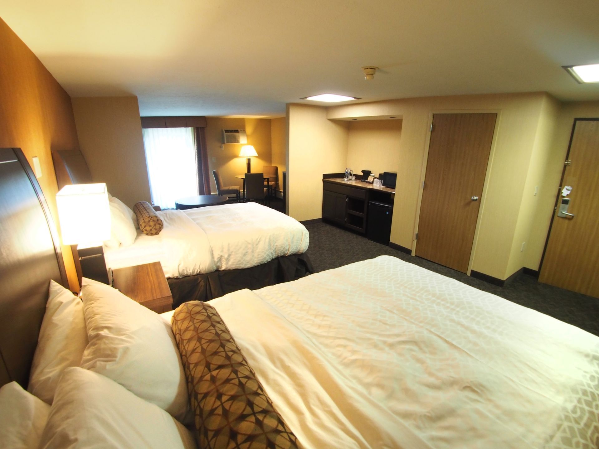 Two queen beds in a Standard room with walkout at Evergreen Resort in Cadillac.