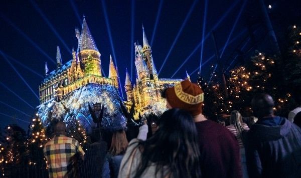 Hogwarts Castle at Universal Orlando lit up during a Christmas projection show.