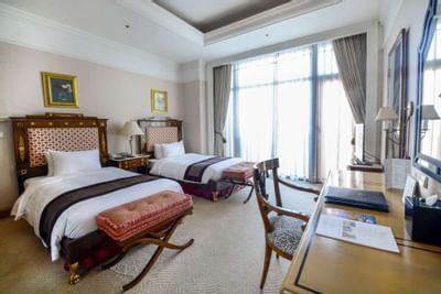 Royal suite with two beds and bed benches at Hanoi Daewoo Hotel