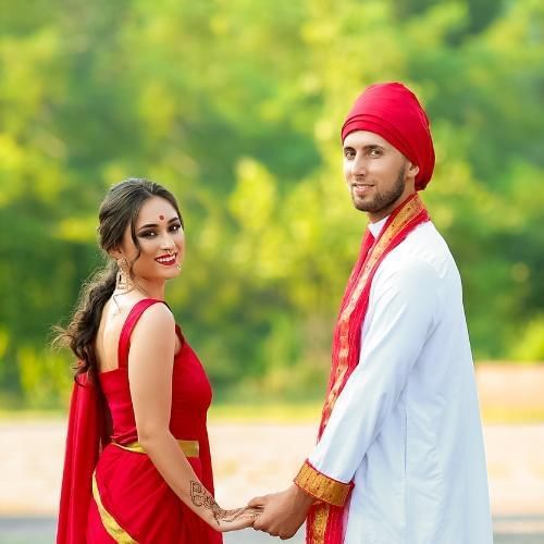 Bride and groom posing for a photo at gorse hill one of the best Hindu wedding venues in Surrey
