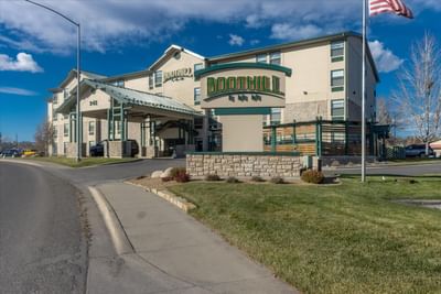 Low-angle view of hotel exterior and street at Boothill Inn & Suites