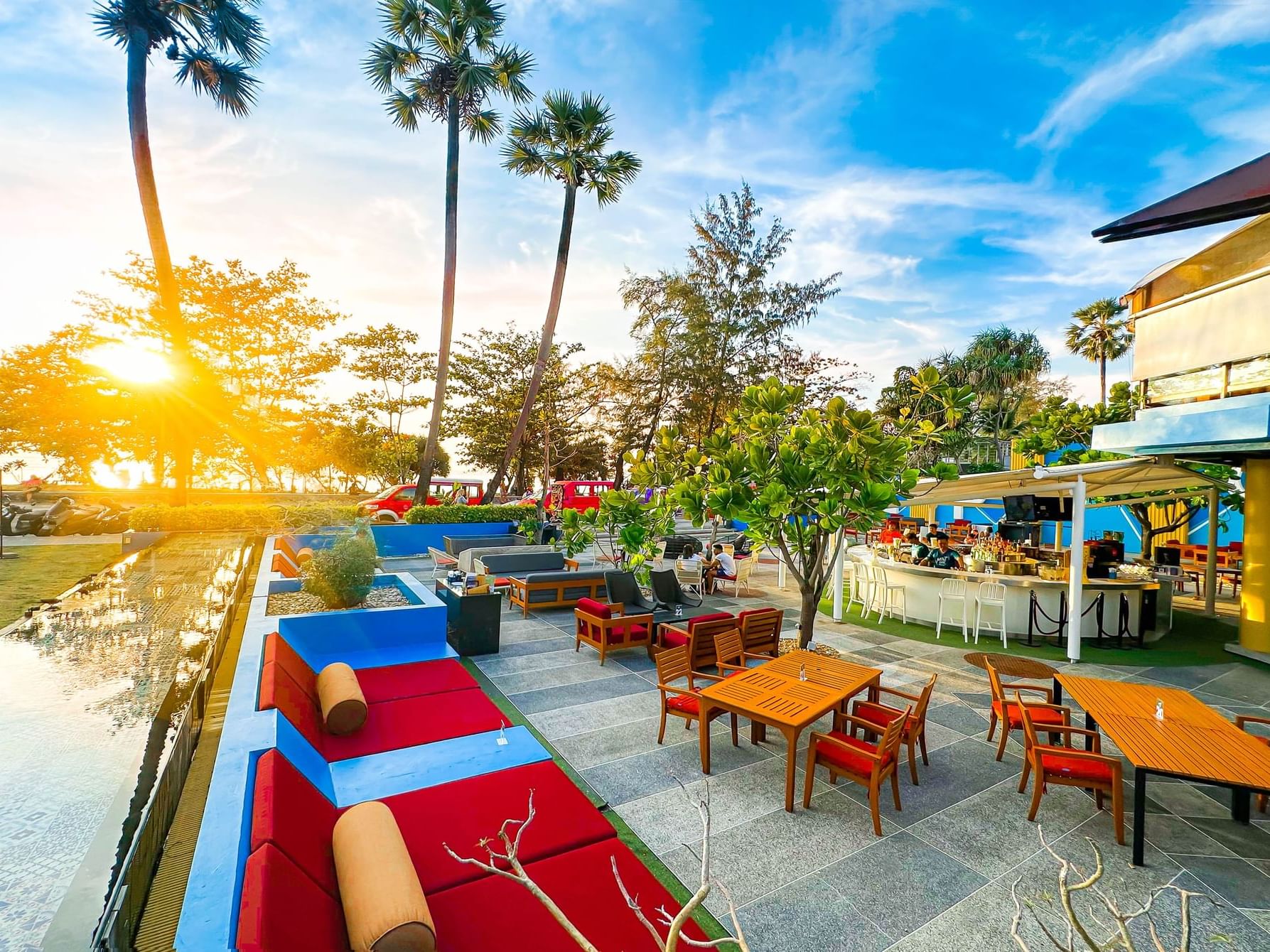 MINT Bar & Restaurant Outdoor area with sofa in the evening vibes with beautiful sunet