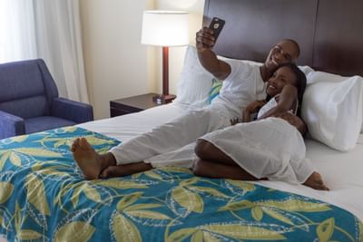 Couple taking a selfie on a bed at Holiday Inn Montego Bay