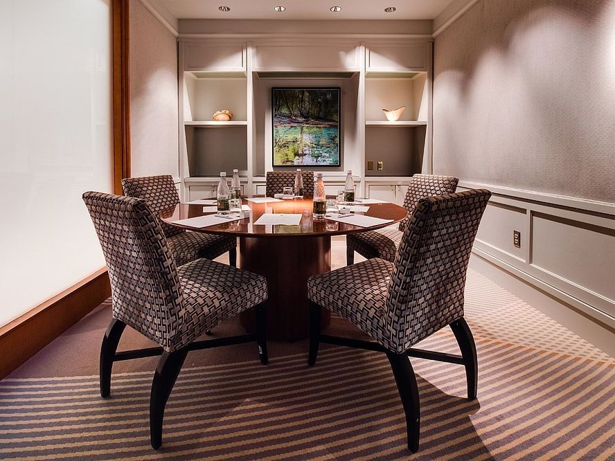 Dining room features a round table surrounded by chairs at Umstead Hotel and Spa
