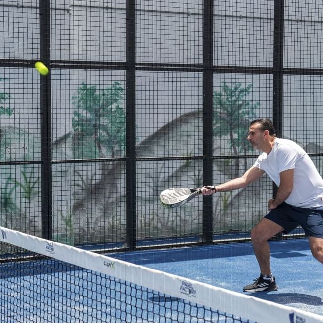 A man playing padel in the padel court 