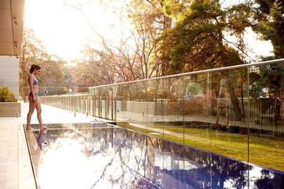 Lady getting in the infinity pool at Knightsbridge Canberra