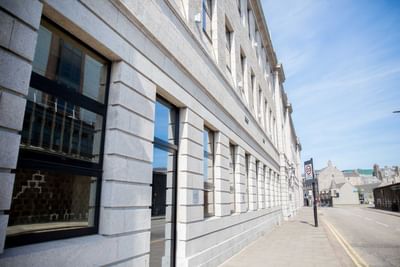 The exterior of the Sandman Signature Aberdeen Hotel, a white br