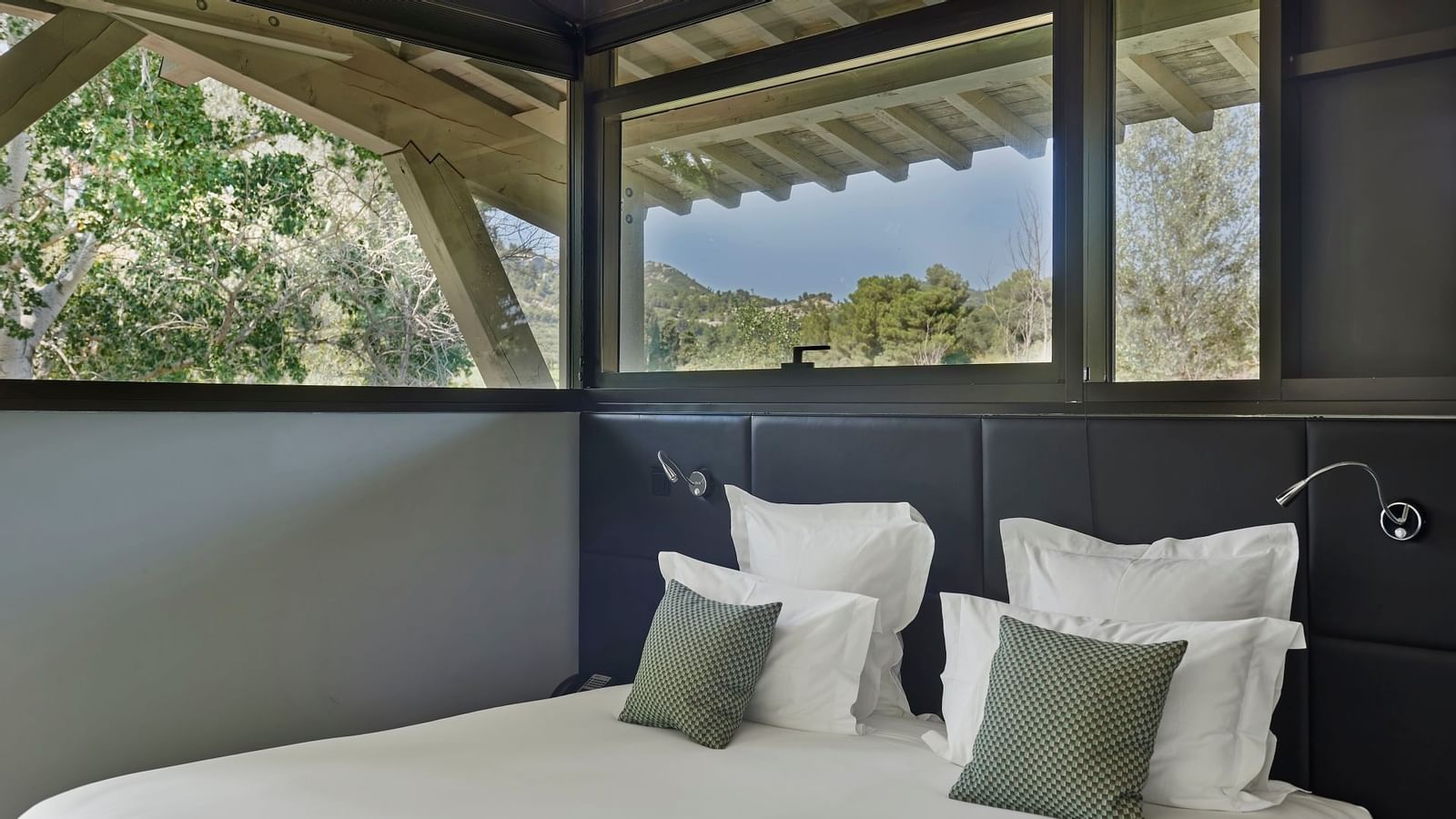 Bed & an outdoor view in Deluxe Villa at Domaine de Manville