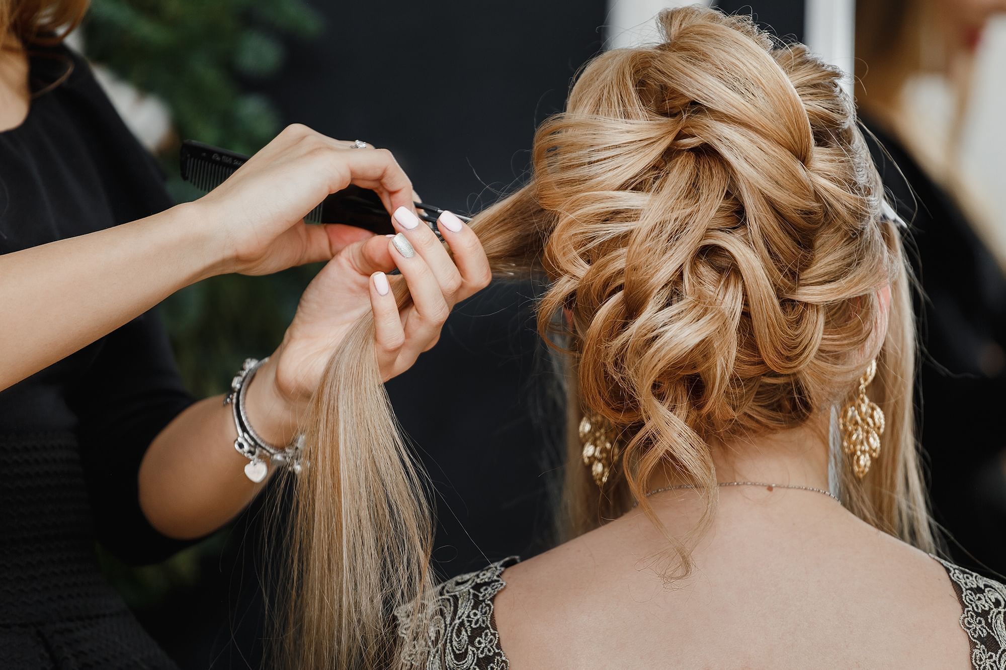 A hairstylist expertly braids in the salon at The Spa by Warwick Melrose