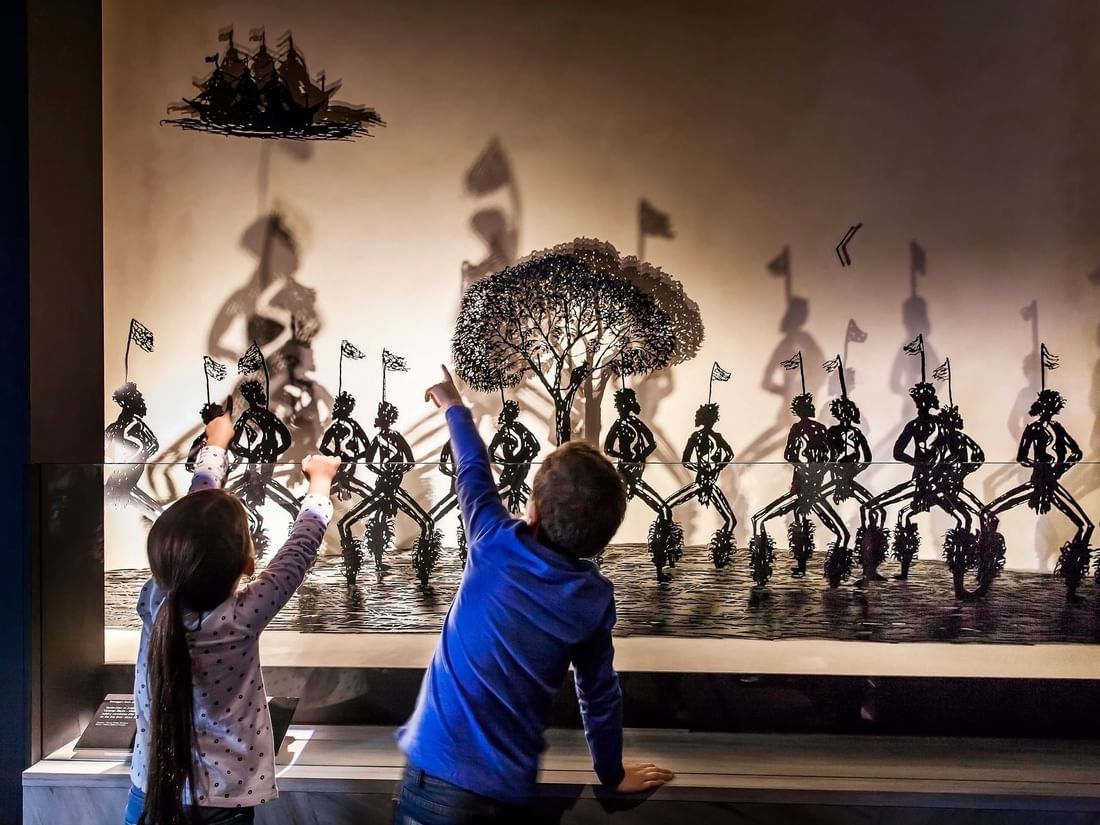 Kids observing the art in Melbourne Museum near Quay West Suites Melbourne