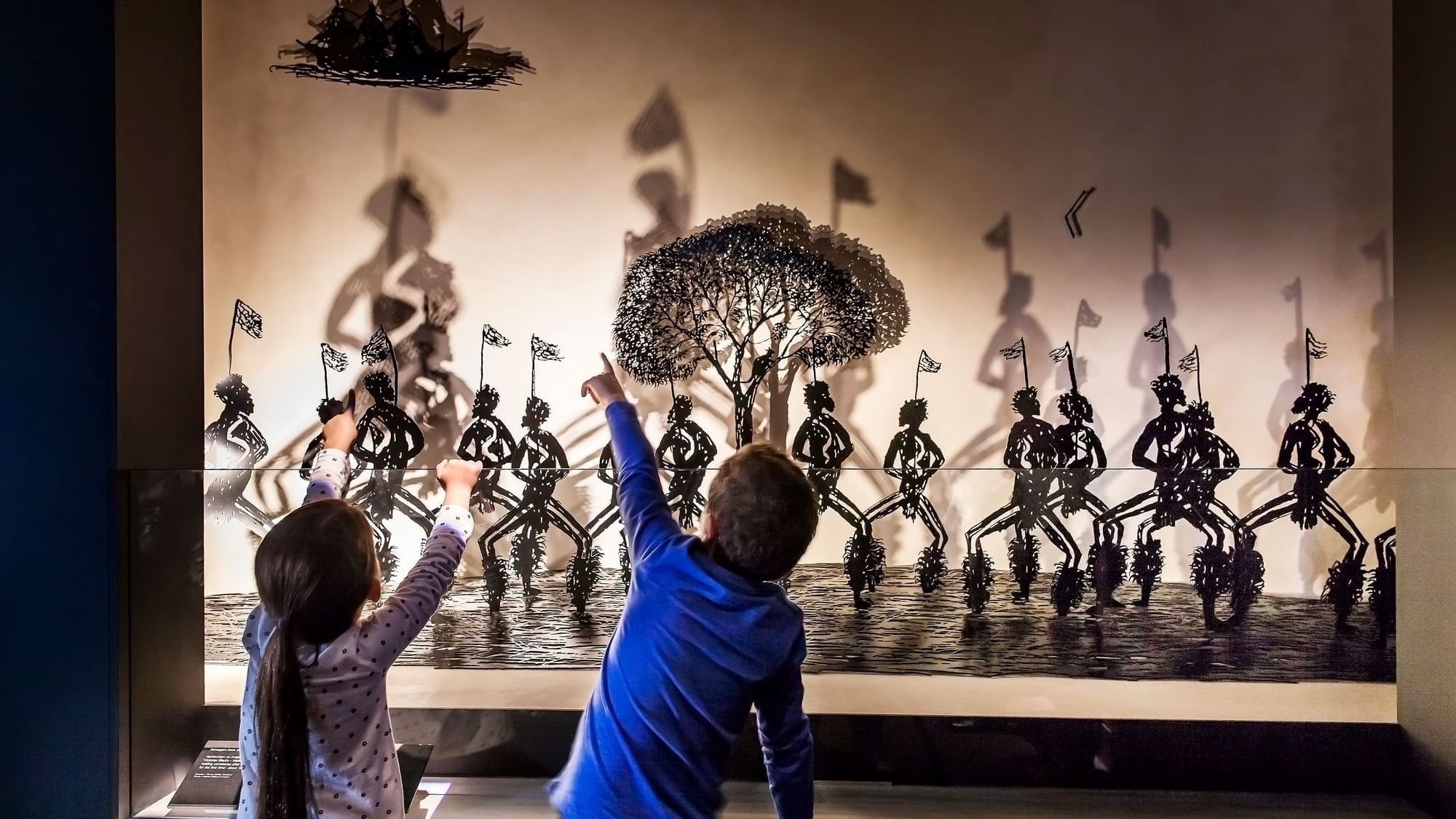 Kids observing the art in Melbourne Museum near Quay West Suites Melbourne