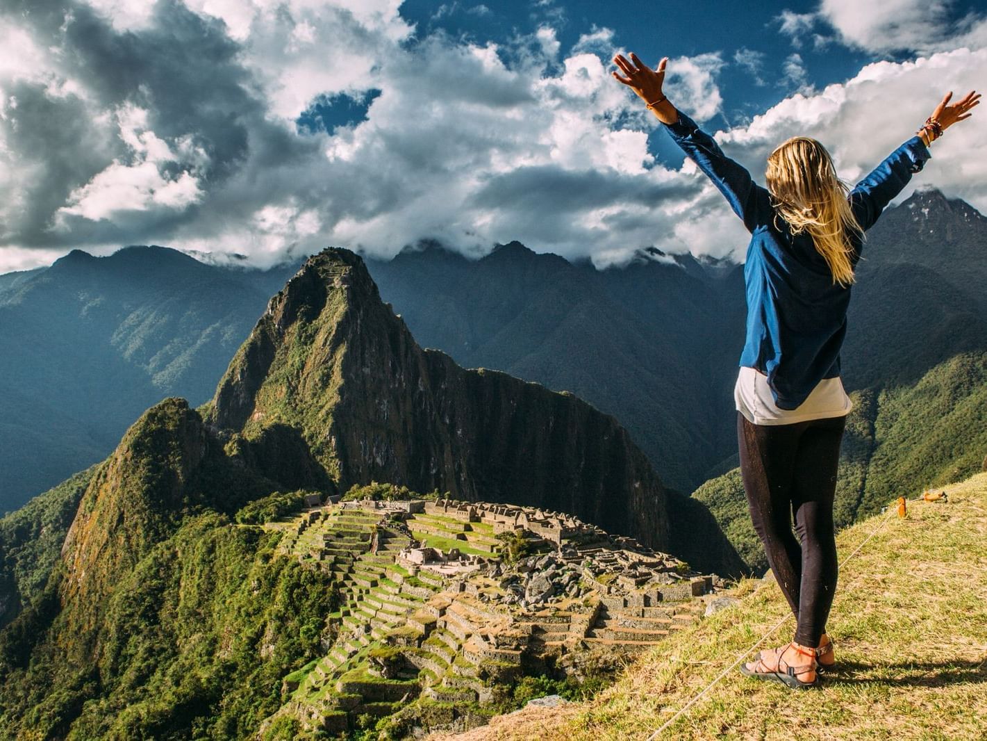 A girl on top of Machu Picchu mountain near Hotel Sumaq