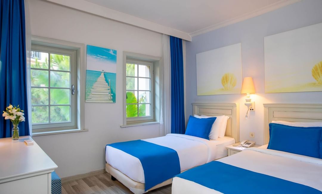 Twin beds with lamp in a Suite bedroom at Bodrum Imperial 