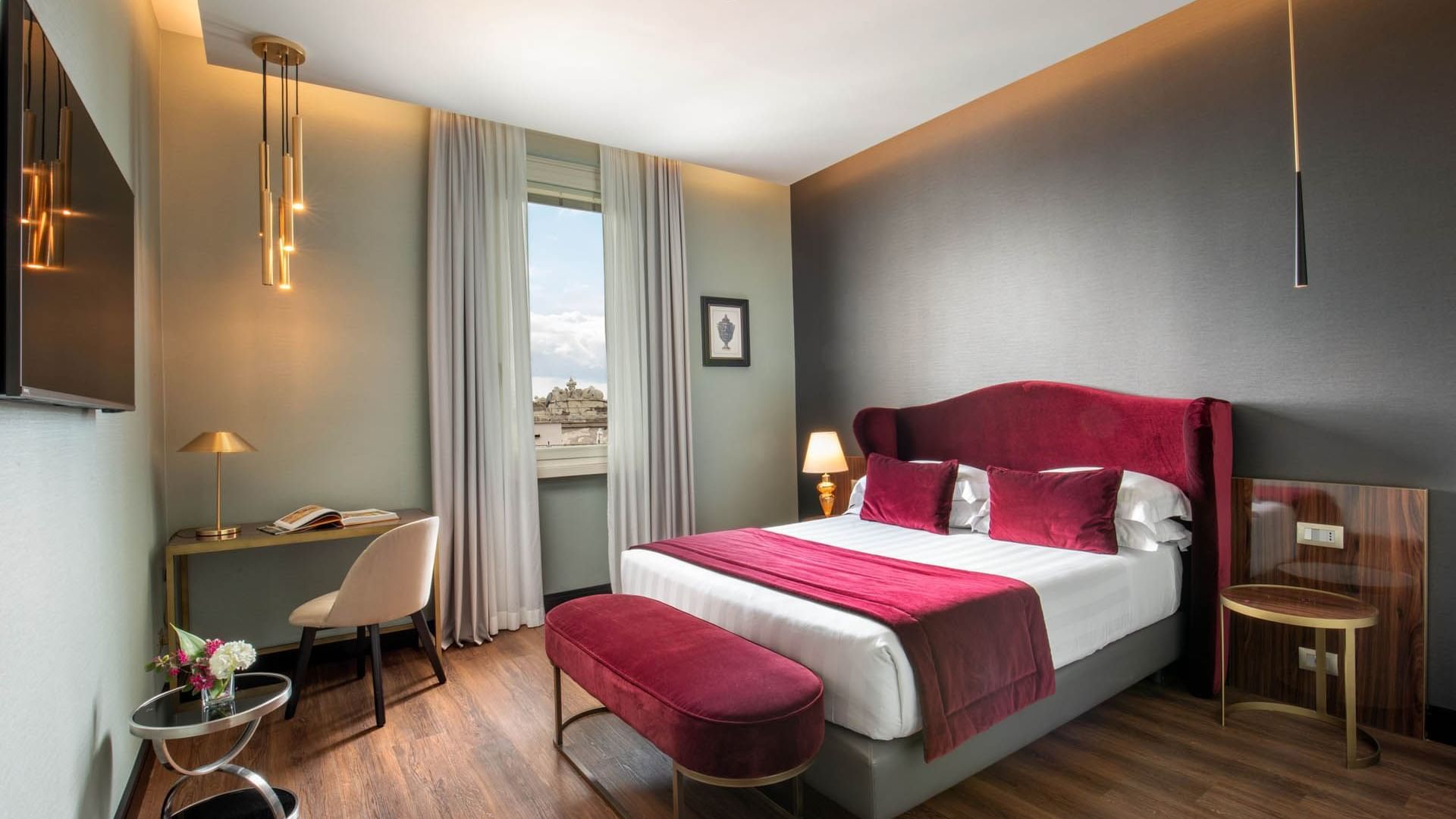 Guardian Suite at The Guardian Hotel with a plush king bed, modern decor, a work desk, and a city-view window