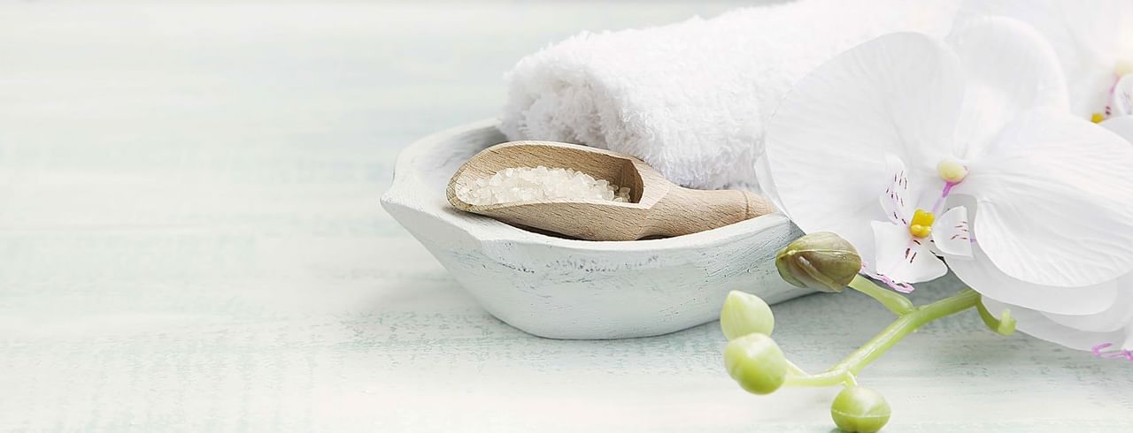 Epsom salt, white flowers and white towel