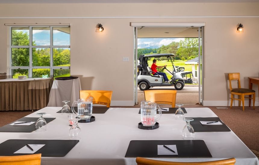 Meeting table with water pitchers by an open doorway in Brudenell/Dundarave at Rodd Brudenell River Resort