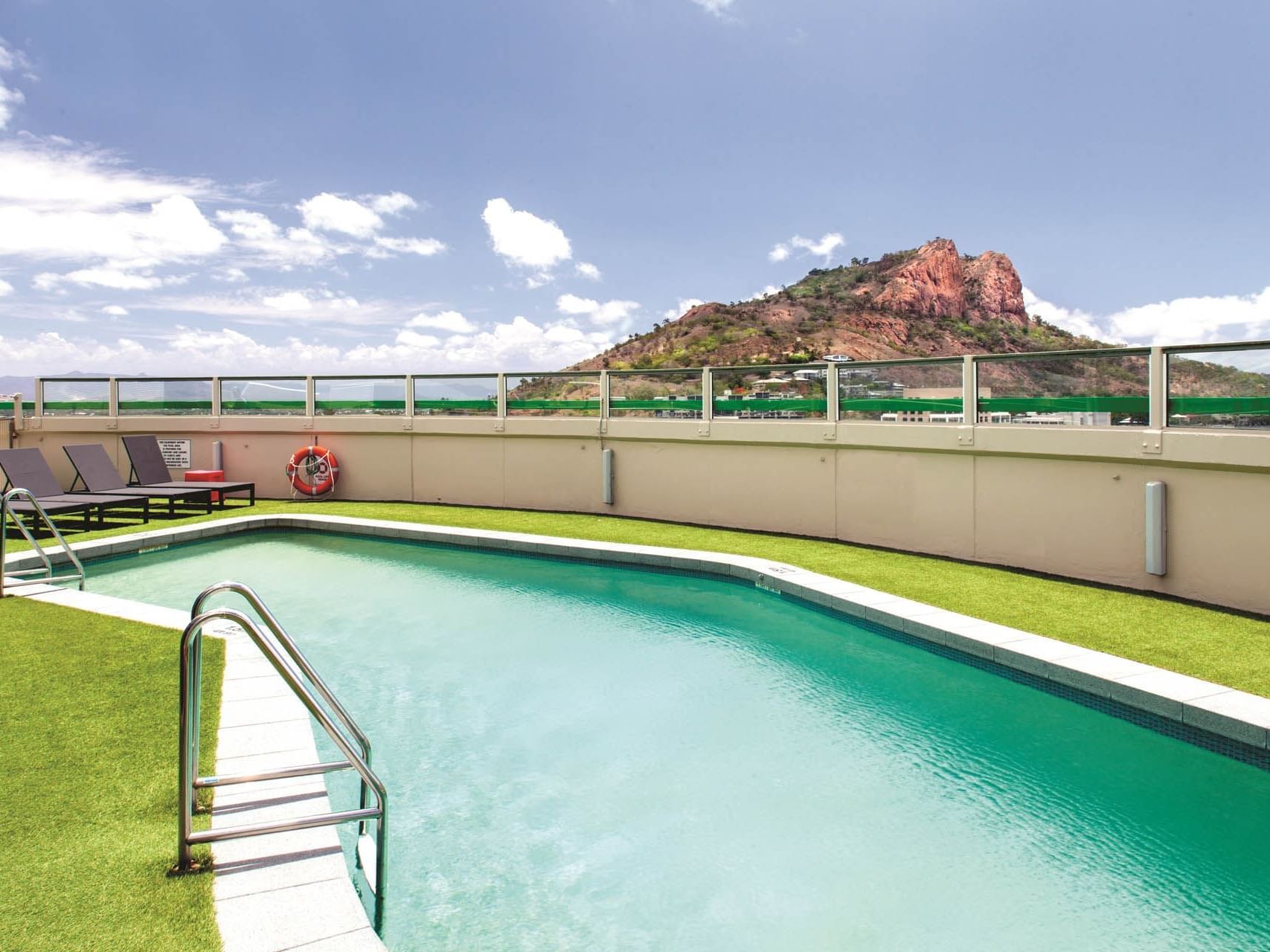Rooftop Pool area with a mountain view at Hotel Grand Chancellor Townsville