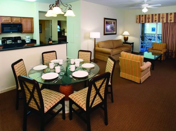 Living area with dining table in a cozy suite at Lake Buena Vista Resort Village & Spa