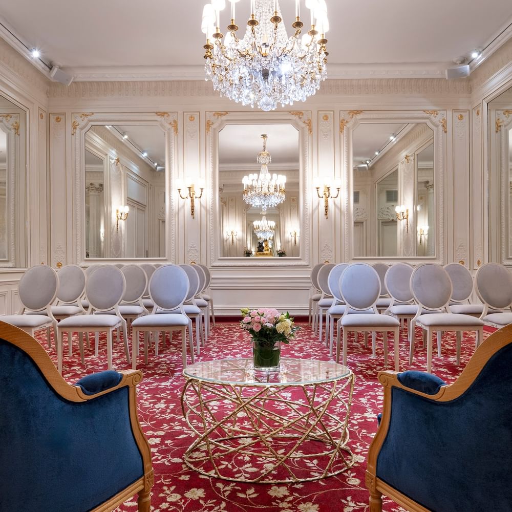 Armchair with a glass coffee table facing the theater set up in Capucines Meeting Room at Hotel Westminster Paris