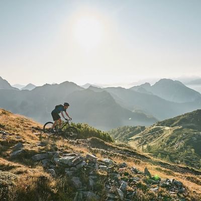 A boy cycling on a mountain near Falkensteiner Hotels