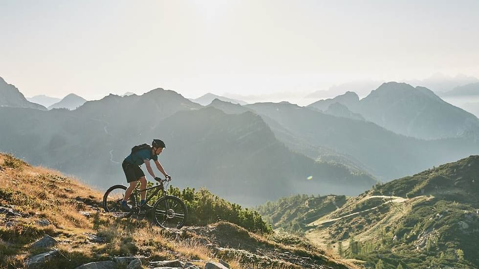 A boy cycling on a mountain near Falkensteiner Hotels