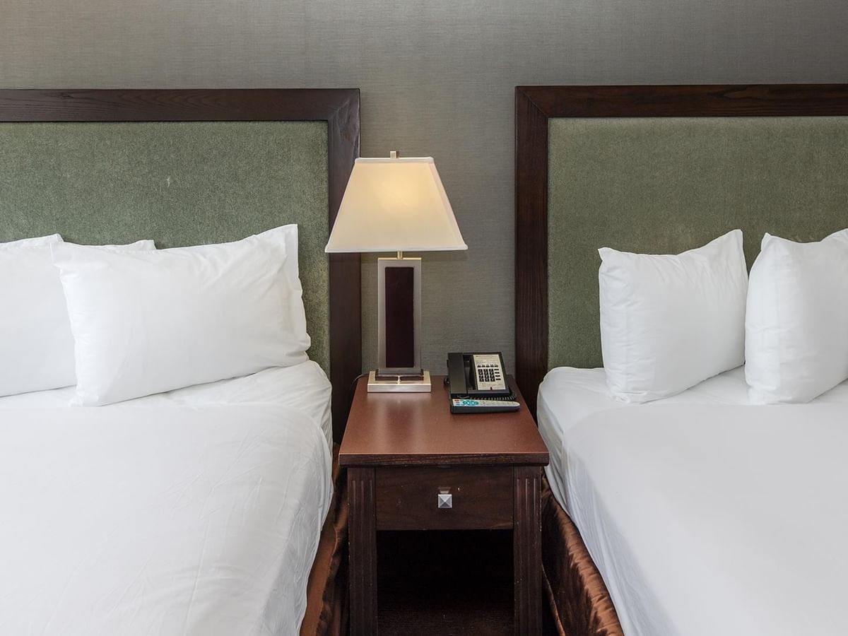 Two queen beds and a nightstand.
