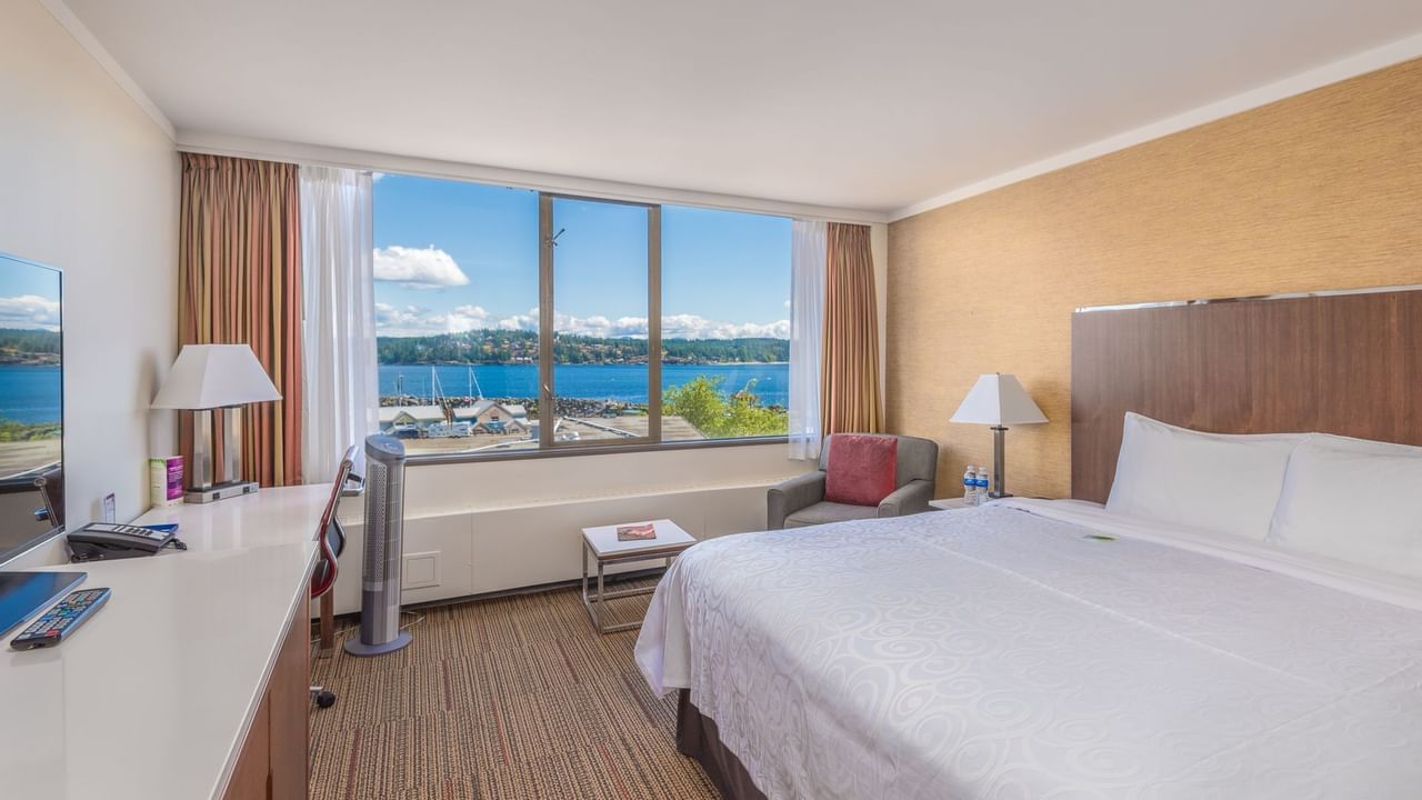 King bed in hotel room with ocean view