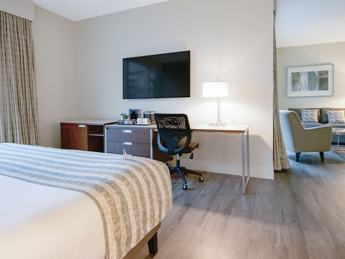 big room bed with tv and sofa chair