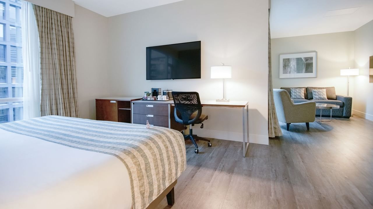 big room bed with tv and sofa chair
