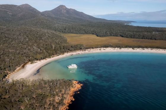 Aerial view of a boat on a cruise in Wineglass Bay near Freycinet Lodge