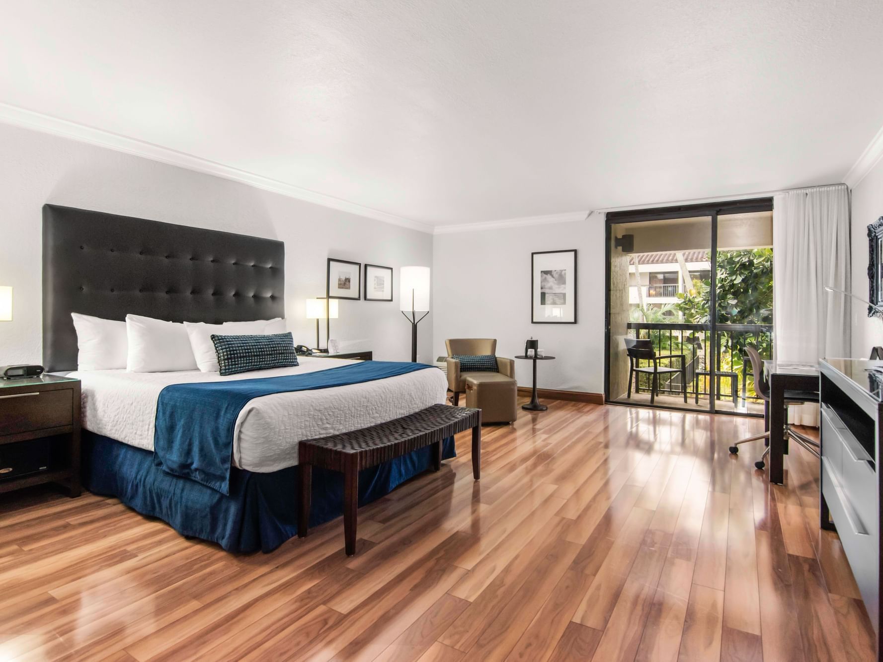 King bed and work area in Junior Suite with wooden floors at Miami Lakes Hotel