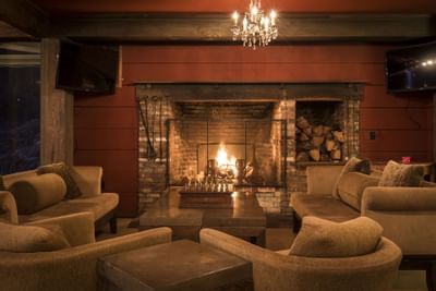 Sofas around fireplace in rental house at Heritage House Resort