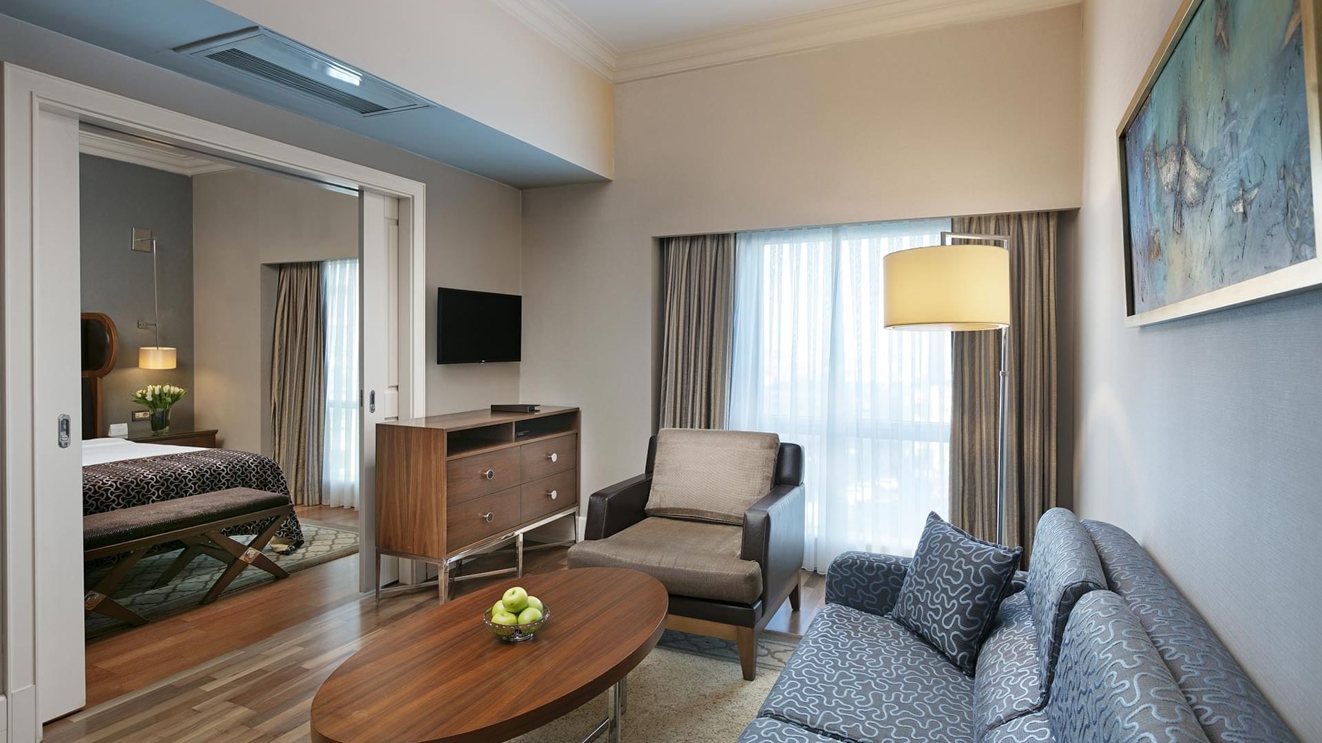 Cozy loungers were arranged by the bed room in Club Suite at Titanic Business Kartal